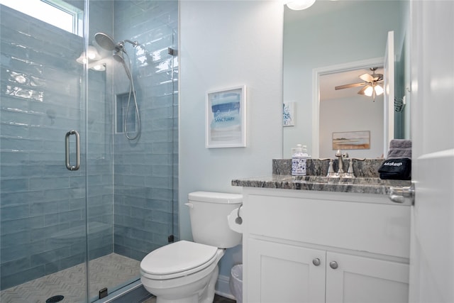 4413 Strand Ave, Port Bolivar, TX 77650 - bathroom featuring a stall shower, vanity, toilet, and a ceiling fan