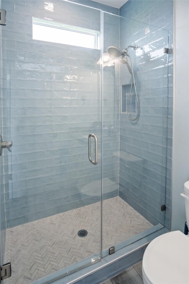 4413 Strand Ave, Port Bolivar, TX 77650 - bathroom featuring toilet, healthy amount of natural light, and a shower stall