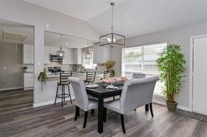 dining area with baseboards, dark wood-style floors, and lofted ceiling