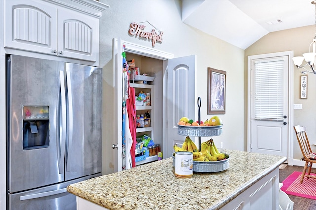 112 Timberside Dr, Conroe, TX 77304 - kitchen with stainless steel refrigerator with ice dispenser, wood finished floors, light stone countertops, a kitchen island, and lofted ceiling