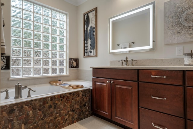 full bathroom with plenty of natural light, tile patterned floors, a garden tub, and vanity