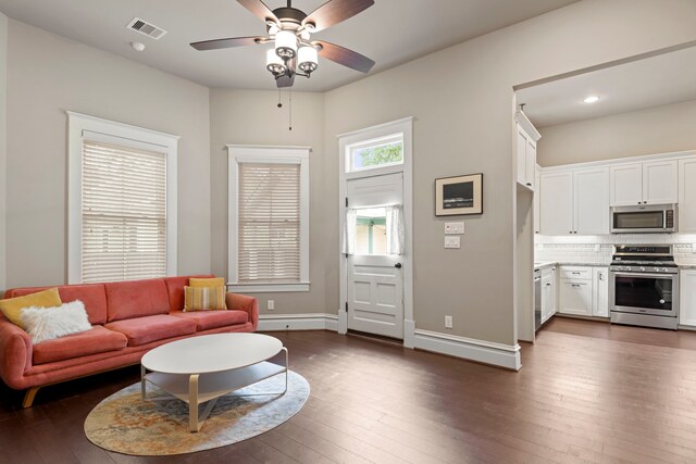 1708 Shearn St, Houston, TX 77007 - living room featuring dark wood-style flooring, a ceiling fan, baseboards, and recessed lighting