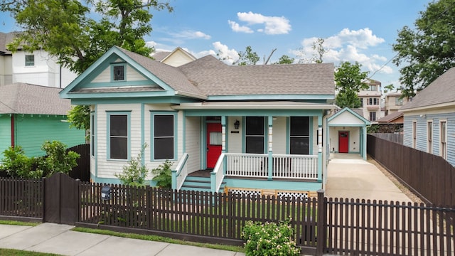 1708 Shearn St, Houston, TX 77007 - view of front of house with a porch, a fenced front yard, and a shingled roof