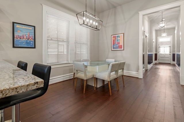 1708 Shearn St, Houston, TX 77007 - dining space with dark wood-style flooring, baseboards, a chandelier, and a baseboard heating unit