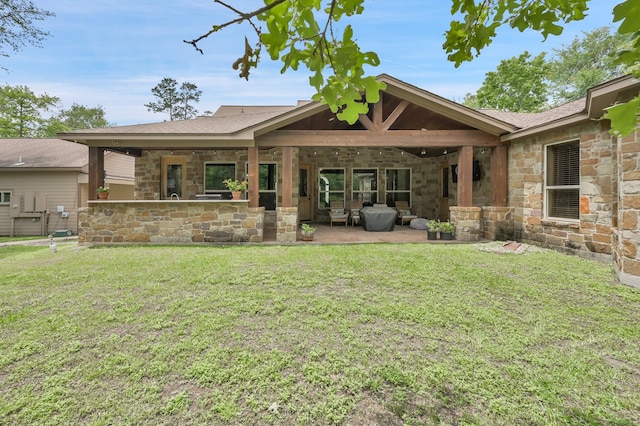 9948 Roda Dr, Conroe, TX 77303 - rear view of property with a patio area, a yard, and stone siding