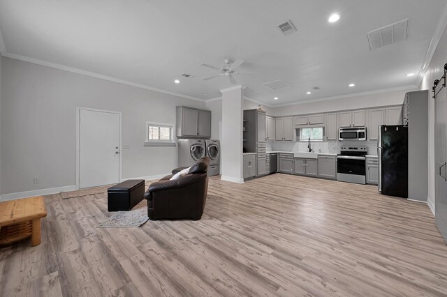 9948 Roda Dr, Conroe, TX 77303 - interior space featuring independent washer and dryer, visible vents, gray cabinetry, open floor plan, and stainless steel appliances