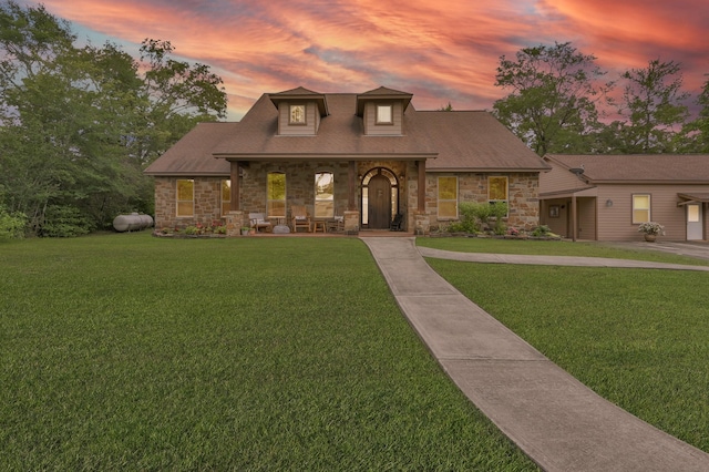 9948 Roda Dr, Conroe, TX 77303 - view of front of property featuring covered porch, a front yard, and stone siding