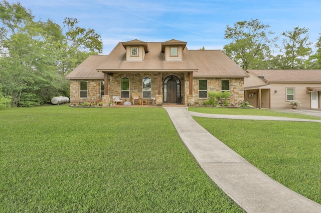 9948 Roda Dr, Conroe, TX 77303 - view of front facade featuring a porch, roof with shingles, a front yard, and stone siding