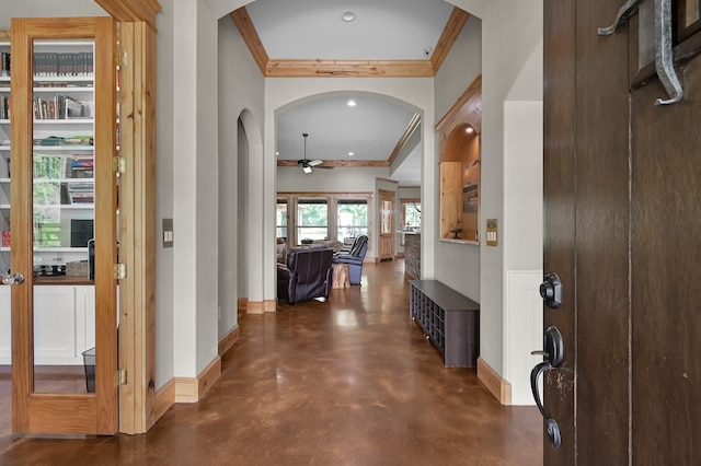 9948 Roda Dr, Conroe, TX 77303 - foyer with crown molding, ceiling fan, finished concrete flooring, arched walkways, and baseboards