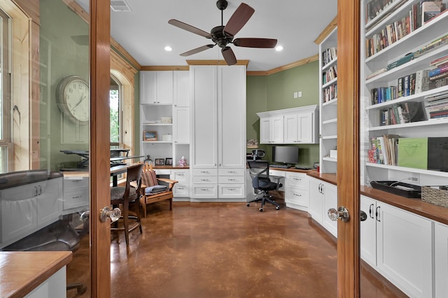 9948 Roda Dr, Conroe, TX 77303 - home office with ceiling fan, built in desk, finished concrete floors, visible vents, and ornamental molding