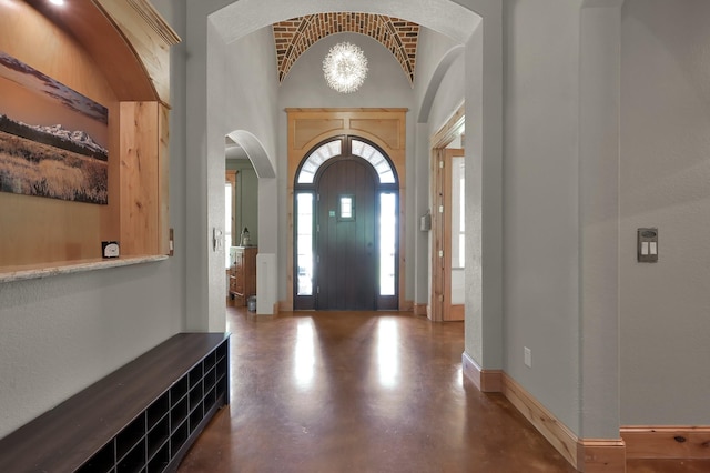 9948 Roda Dr, Conroe, TX 77303 - foyer with finished concrete flooring, arched walkways, and vaulted ceiling