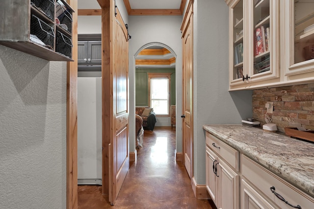 9948 Roda Dr, Conroe, TX 77303 - corridor with arched walkways, a textured wall, baseboards, and finished concrete flooring