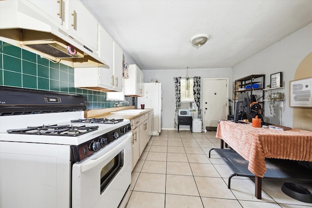 1206 Shearn St, Houston, TX 77007 - kitchen with white gas range oven, a sink, white cabinetry, backsplash, and under cabinet range hood