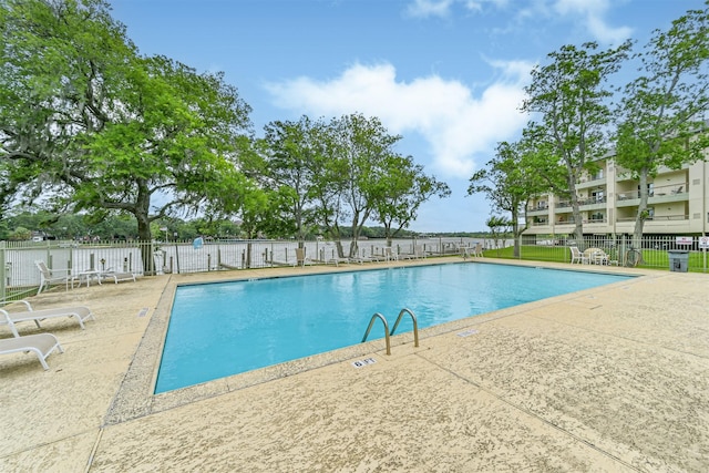 pool featuring a patio area and fence
