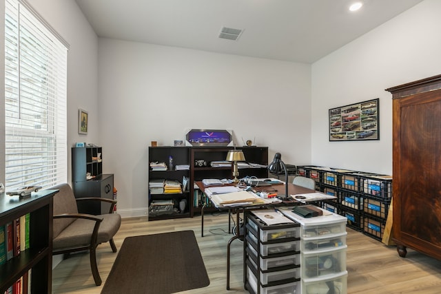 office space with visible vents, a healthy amount of sunlight, and light wood-type flooring