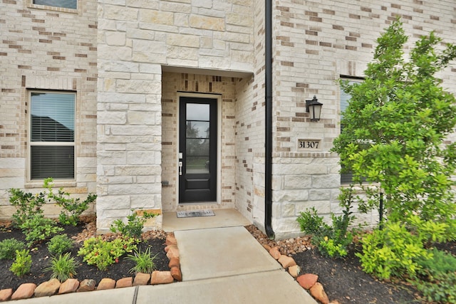 doorway to property with stone siding