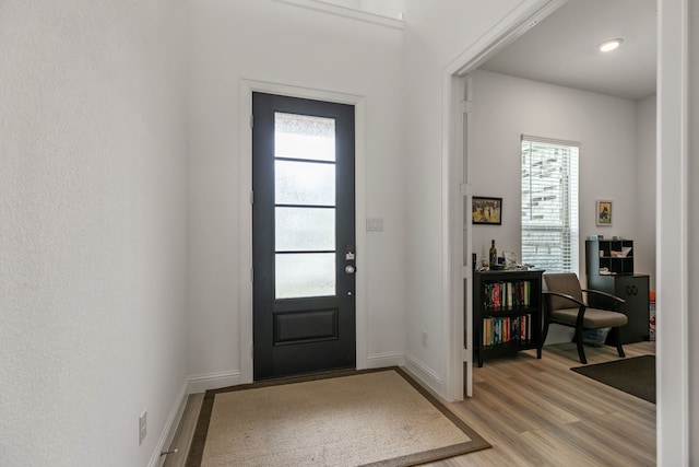 entrance foyer featuring baseboards and light wood finished floors