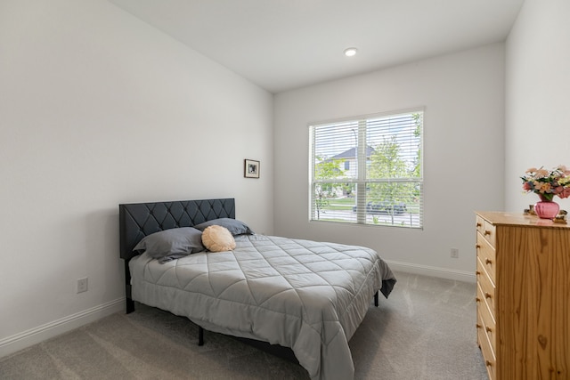 carpeted bedroom featuring baseboards and recessed lighting