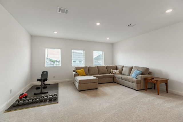 living room with visible vents, recessed lighting, baseboards, and light carpet