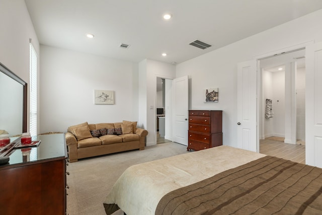 bedroom featuring visible vents, recessed lighting, and light colored carpet