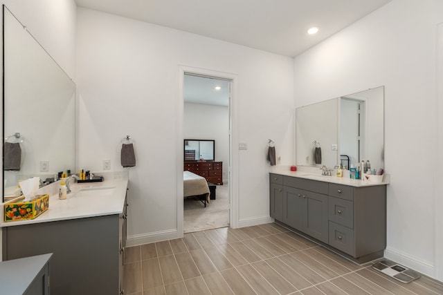ensuite bathroom with ensuite bath, visible vents, baseboards, vanity, and recessed lighting