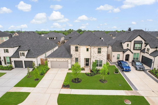 french country home with a residential view, an attached garage, and driveway