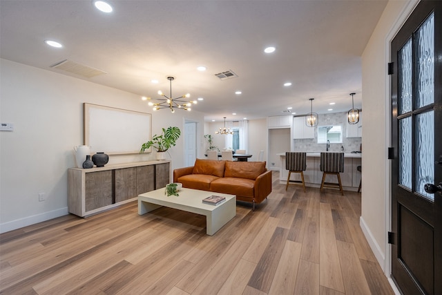living area featuring a chandelier, visible vents, recessed lighting, and light wood-style floors