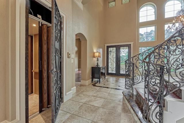 28822 Saddle Oak Dr, Montgomery, TX 77356 - foyer featuring stairs, a towering ceiling, baseboards, french doors, and arched walkways