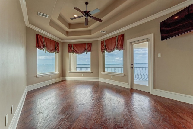 28822 Saddle Oak Dr, Montgomery, TX 77356 - empty room with a ceiling fan, visible vents, wood finished floors, and a raised ceiling
