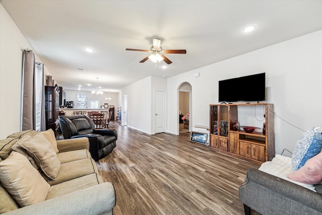 13127 Clifton Hill Ln, Houston, TX 77044 - living room with arched walkways, recessed lighting, wood finished floors, and ceiling fan with notable chandelier