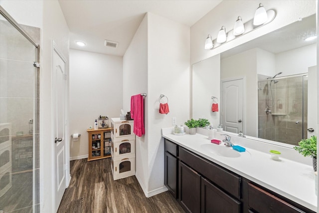 13127 Clifton Hill Ln, Houston, TX 77044 - bathroom with a stall shower, wood finished floors, and visible vents