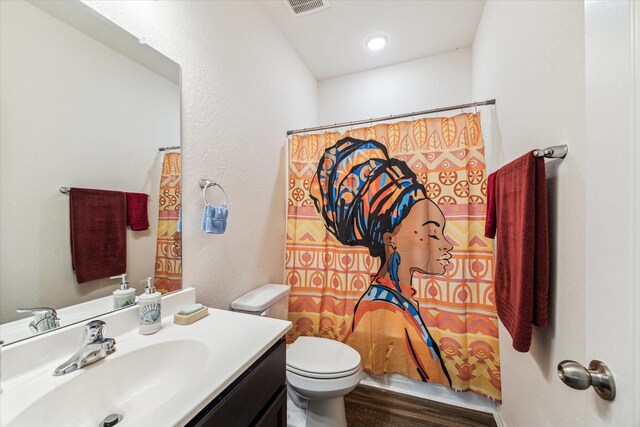13127 Clifton Hill Ln, Houston, TX 77044 - bathroom with vanity, toilet, curtained shower, wood finished floors, and visible vents