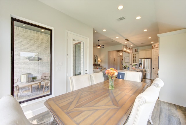 dining area with light wood-style floors, ceiling fan, visible vents, and recessed lighting