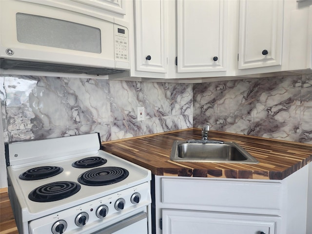 6102 Seawall Blvd Unit 213, Galveston, TX 77551 - kitchen with a sink, wood counters, white cabinetry, white appliances, and decorative backsplash