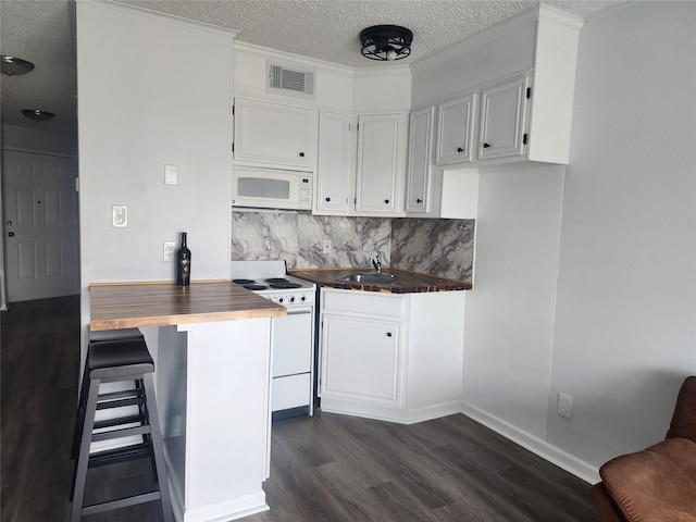 6102 Seawall Blvd Unit 213, Galveston, TX 77551 - kitchen featuring a textured ceiling, white appliances, wooden counters, visible vents, and dark wood-type flooring