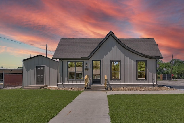 917 Houston St, Conroe, TX 77301 - modern farmhouse style home with a shingled roof, board and batten siding, and a lawn