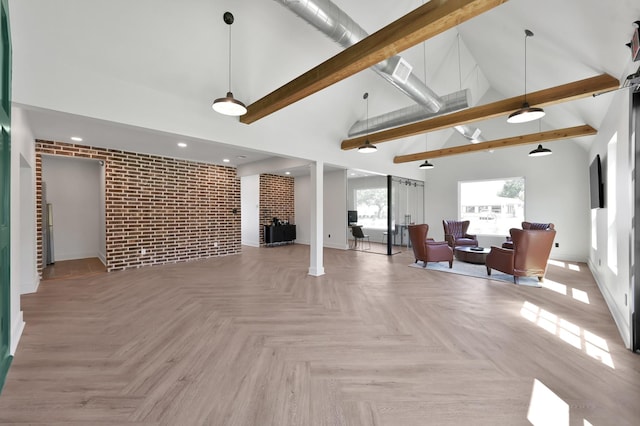 917 Houston St, Conroe, TX 77301 - living area featuring baseboards, brick wall, beam ceiling, and high vaulted ceiling