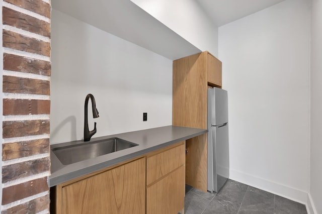 917 Houston St, Conroe, TX 77301 - kitchen featuring dark countertops, a sink, freestanding refrigerator, baseboards, and modern cabinets