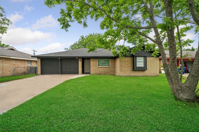 ranch-style home featuring brick siding, a garage, a front lawn, and driveway