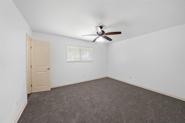 unfurnished room featuring baseboards, ceiling fan, and dark carpet