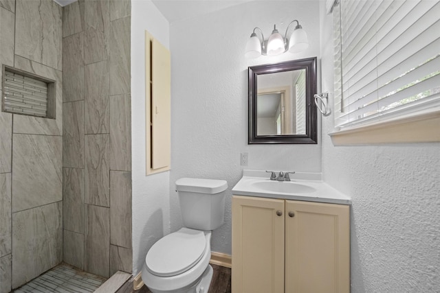 2326 20th Ave N, Texas City, TX 77590 - bathroom with vanity, toilet, and tiled shower