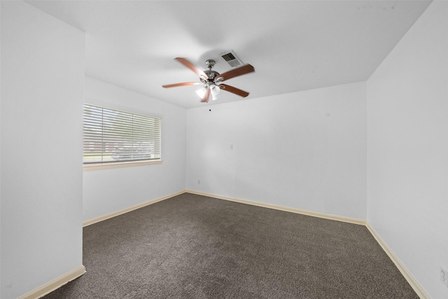 spare room with visible vents, a ceiling fan, carpet, and baseboards