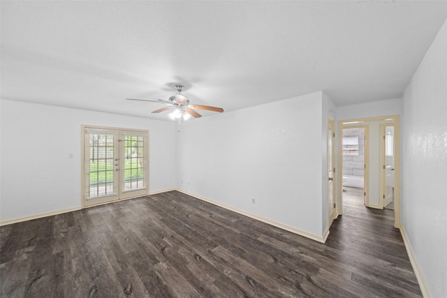 unfurnished room featuring ceiling fan, baseboards, and dark wood-type flooring