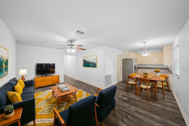 living room featuring baseboards, ceiling fan, dark wood-type flooring, and visible vents