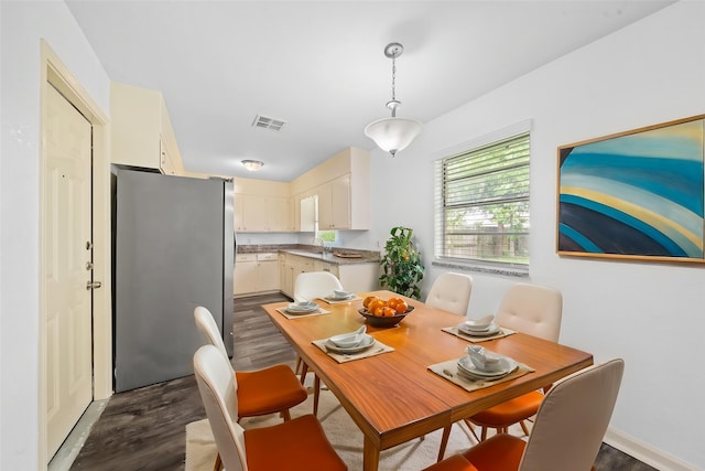 dining room featuring visible vents and dark wood finished floors