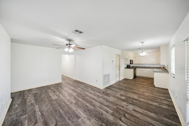 2326 20th Ave N, Texas City, TX 77590 - unfurnished living room featuring a sink, dark wood-style floors, ceiling fan, and baseboards