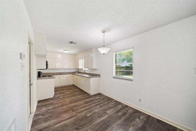 2326 20th Ave N, Texas City, TX 77590 - kitchen featuring dark wood finished floors, decorative light fixtures, baseboards, and white cabinets