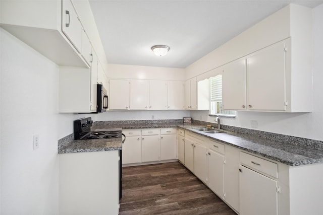 2326 20th Ave N, Texas City, TX 77590 - kitchen with a sink, dark wood finished floors, white cabinetry, and dark countertops