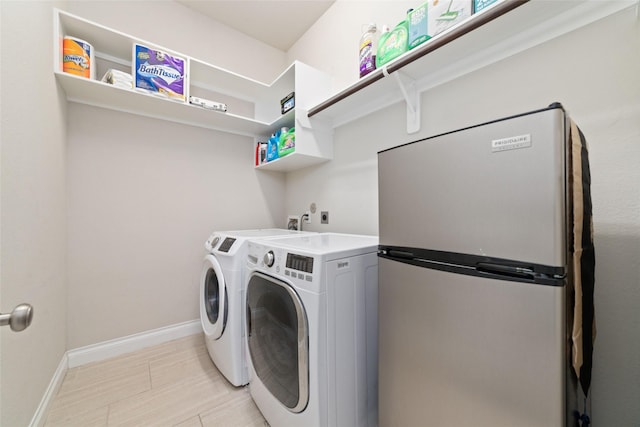 11143 Dunstan Hill Dr, Richmond, TX 77407 - laundry area with separate washer and dryer and baseboards