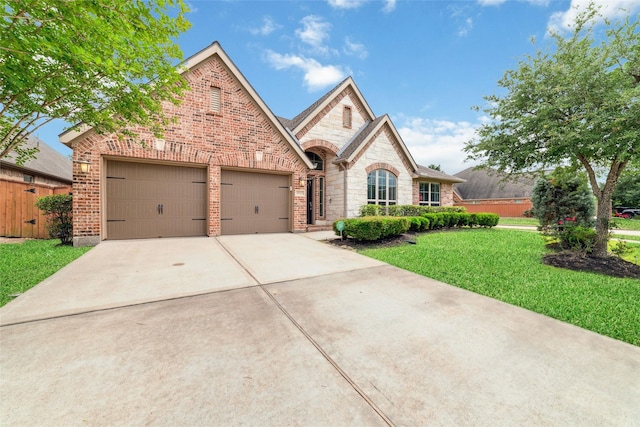11143 Dunstan Hill Dr, Richmond, TX 77407 - french country style house with driveway, stone siding, a garage, and brick siding